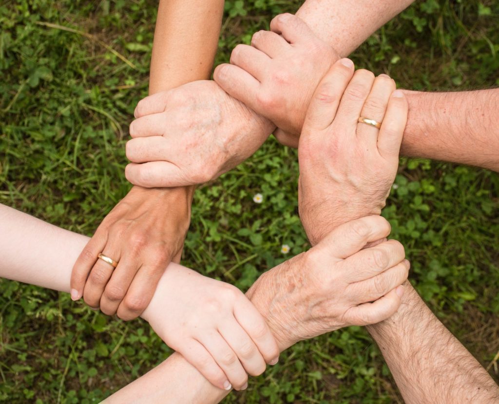 Group of people holding wrists
